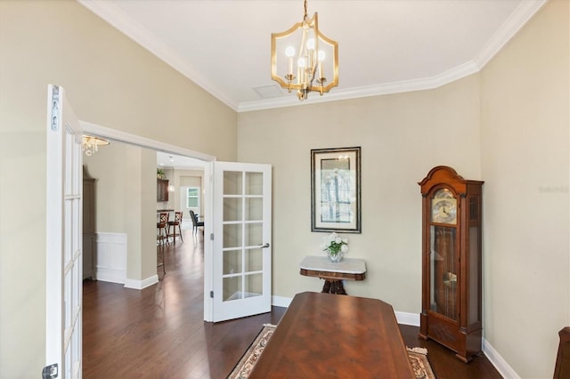 dining space with ornamental molding, dark hardwood / wood-style floors, a chandelier, and french doors