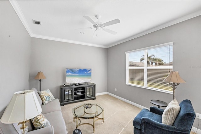 living room with ceiling fan, light colored carpet, and ornamental molding