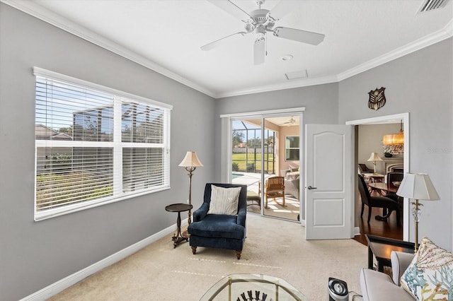 living area featuring crown molding, carpet, and ceiling fan