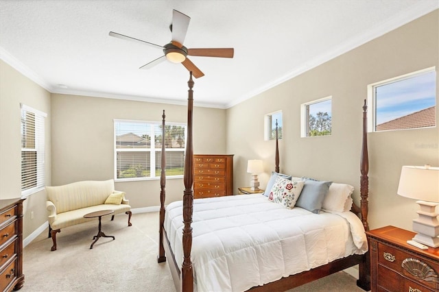 carpeted bedroom with ornamental molding and ceiling fan