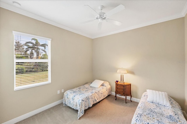 carpeted bedroom featuring ceiling fan and ornamental molding