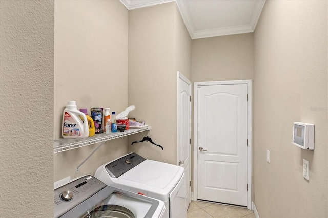 laundry area with ornamental molding, light tile patterned flooring, and independent washer and dryer