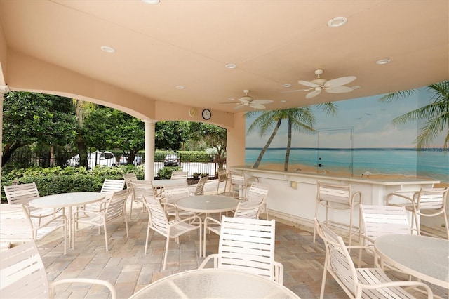 view of patio / terrace with an outdoor bar and ceiling fan