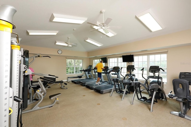 gym featuring ceiling fan, light colored carpet, and vaulted ceiling