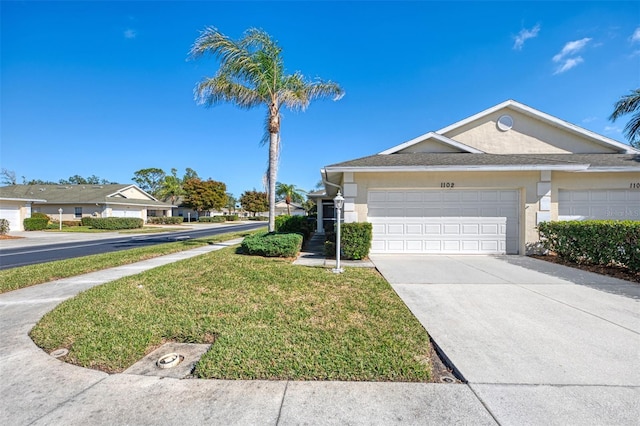 view of front of property with a garage and a front yard