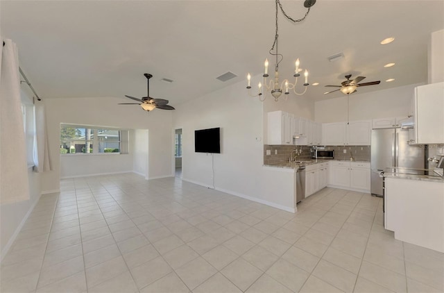 kitchen with sink, stainless steel appliances, white cabinets, light tile patterned flooring, and decorative backsplash