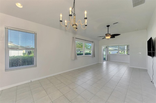 tiled empty room with ceiling fan with notable chandelier