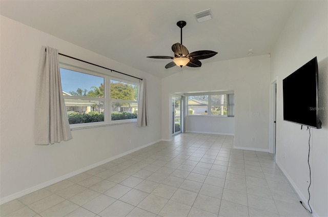 tiled spare room with ceiling fan