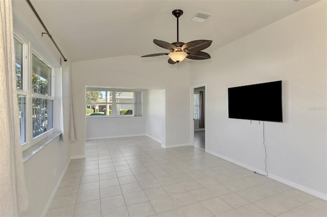 tiled empty room featuring ceiling fan and vaulted ceiling