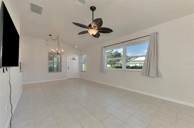 empty room featuring light tile patterned floors, ceiling fan with notable chandelier, and vaulted ceiling