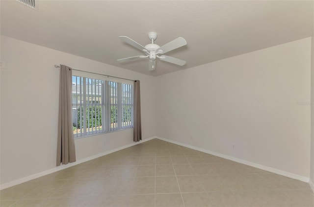 unfurnished room featuring ceiling fan and light tile patterned floors