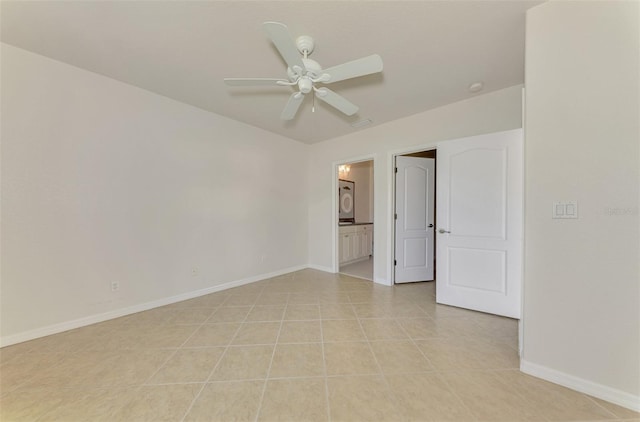 unfurnished room with washer / clothes dryer, light tile patterned floors, and ceiling fan