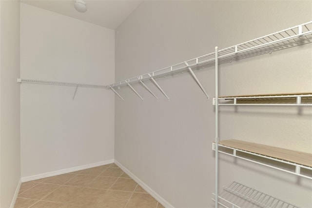 spacious closet featuring tile patterned flooring