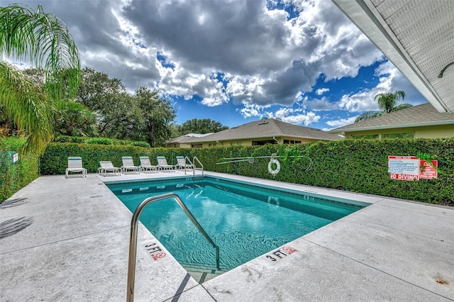 view of swimming pool with a patio