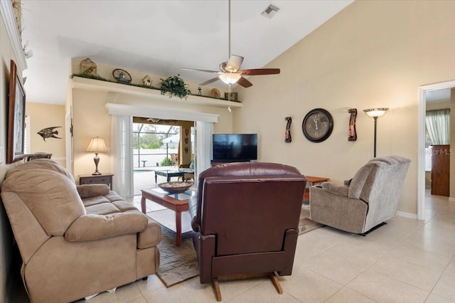 tiled living room with ceiling fan and high vaulted ceiling