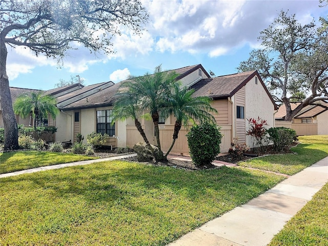 single story home featuring a front yard