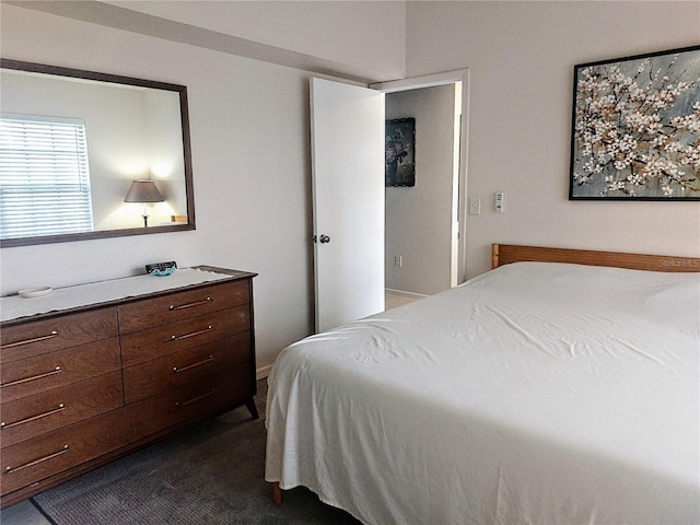 bedroom featuring dark carpet