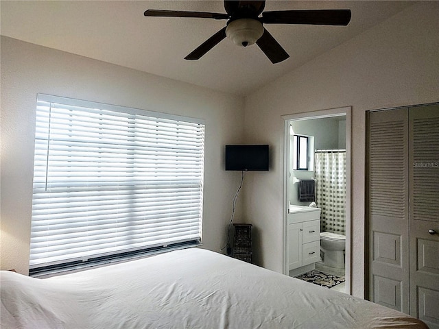 unfurnished bedroom with ensuite bath, vaulted ceiling, and ceiling fan