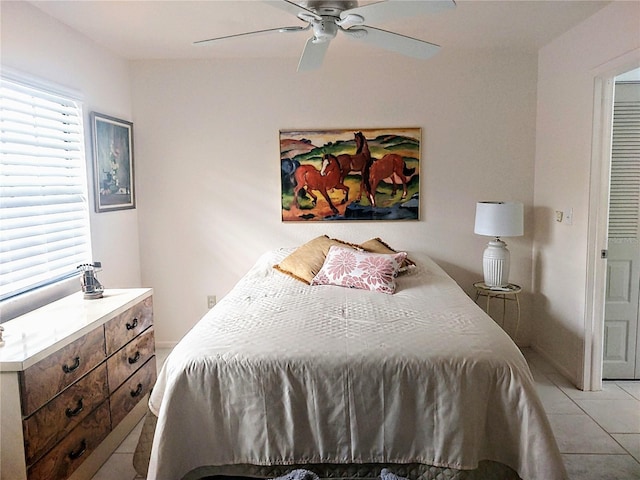 bedroom featuring light tile patterned floors and ceiling fan