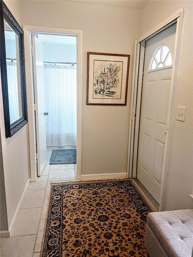 doorway with light tile patterned flooring