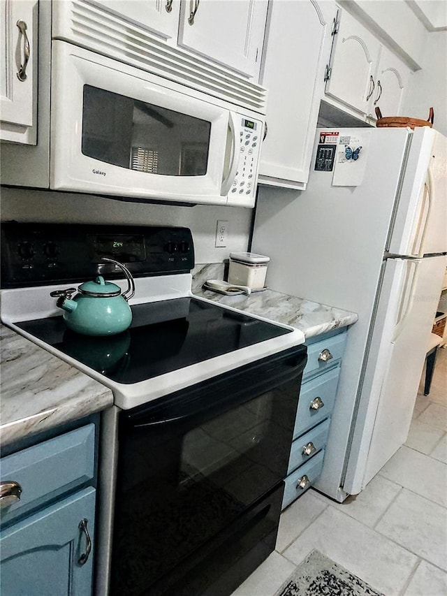 kitchen featuring blue cabinets, light tile patterned floors, white cabinets, and white appliances