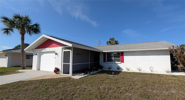 ranch-style house featuring a garage and a front lawn