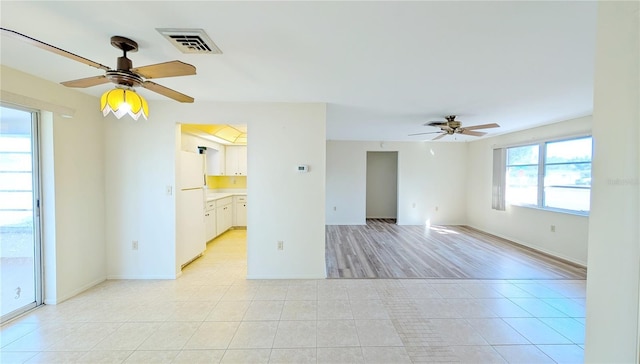 spare room with light tile patterned floors and ceiling fan