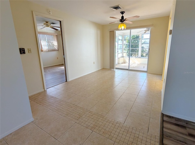 empty room featuring light tile patterned floors and ceiling fan