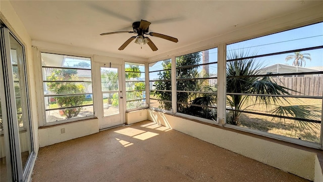 unfurnished sunroom featuring ceiling fan