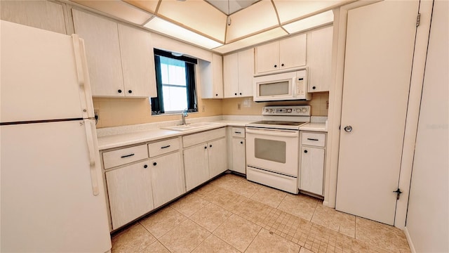 kitchen with tasteful backsplash, sink, light tile patterned floors, and white appliances