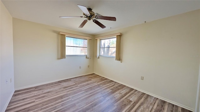 spare room with light hardwood / wood-style flooring and ceiling fan