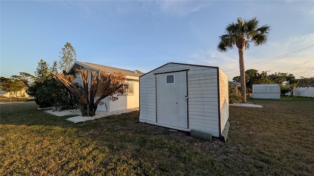 view of outbuilding with a lawn