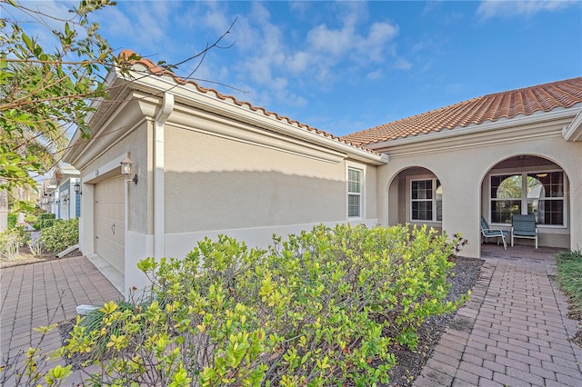 view of side of property with a garage