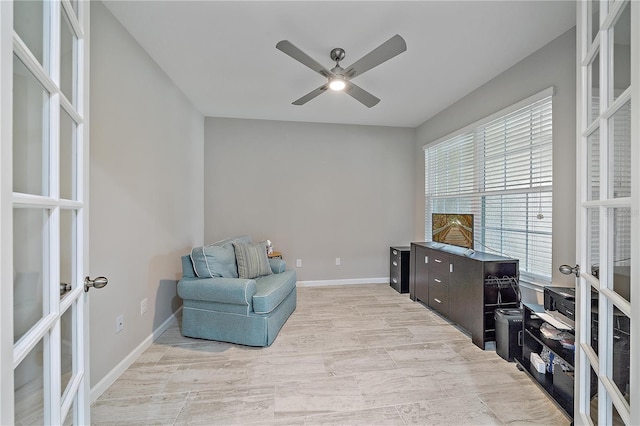 living area with french doors and ceiling fan