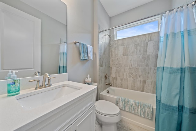 full bathroom with shower / tub combo with curtain, vanity, and toilet