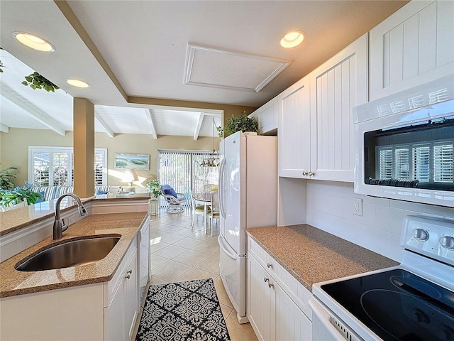 kitchen with white cabinetry, sink, light tile patterned floors, white appliances, and beam ceiling