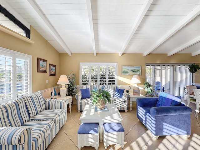 sunroom featuring lofted ceiling with beams and a wealth of natural light