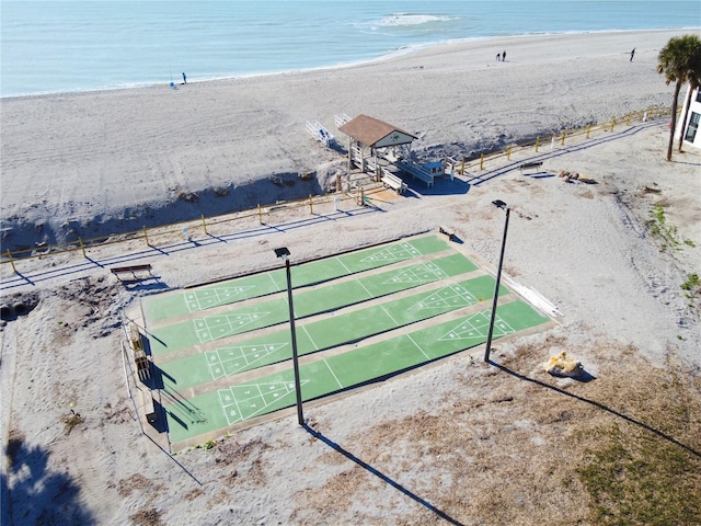 birds eye view of property with a water view and a view of the beach