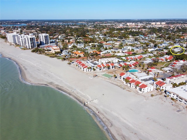 birds eye view of property with a view of the beach and a water view