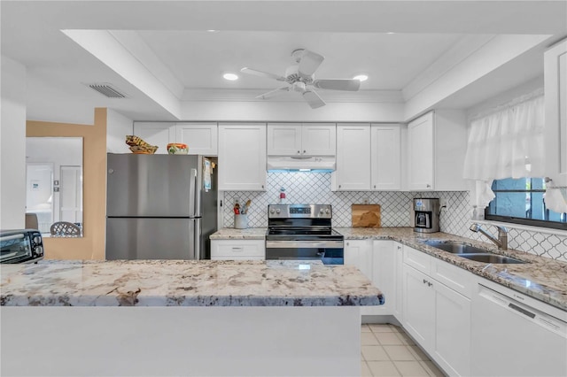 kitchen featuring white cabinetry, stainless steel appliances, sink, and backsplash