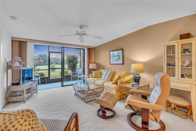 living room with expansive windows, light colored carpet, and ceiling fan