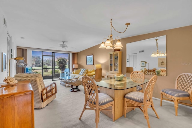 dining room featuring a wall of windows, ceiling fan with notable chandelier, and light carpet