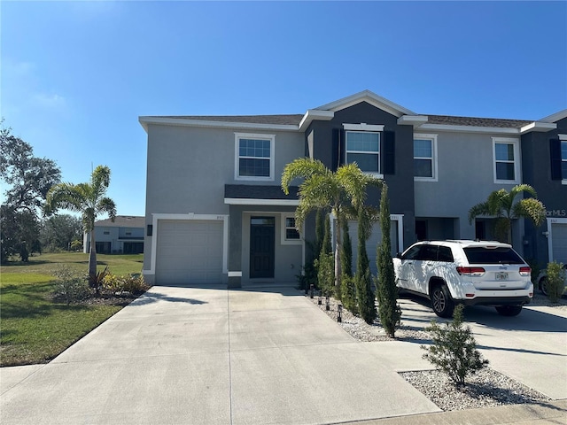 view of front of property with a garage and a front lawn