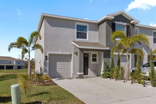 view of front of house with a garage and a front yard