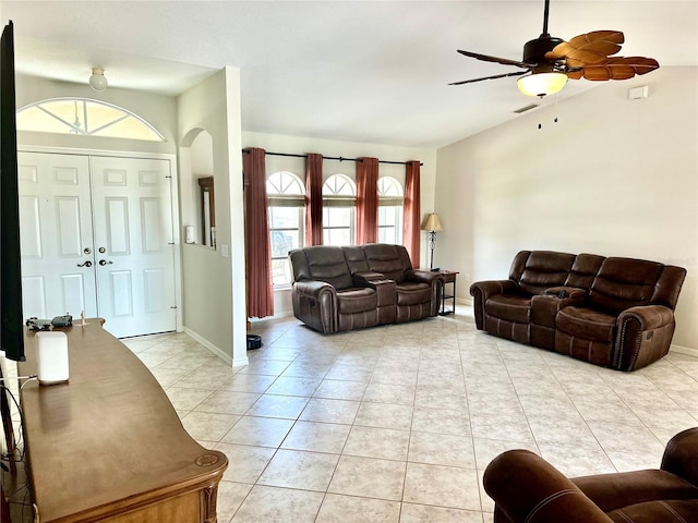 tiled living room featuring lofted ceiling and ceiling fan