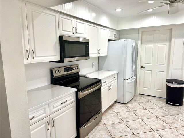 kitchen with white cabinetry, light tile patterned floors, and stainless steel appliances