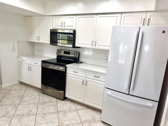 kitchen featuring white cabinetry, appliances with stainless steel finishes, and light tile patterned floors