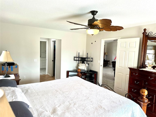 bedroom with ceiling fan, a textured ceiling, and light tile patterned flooring