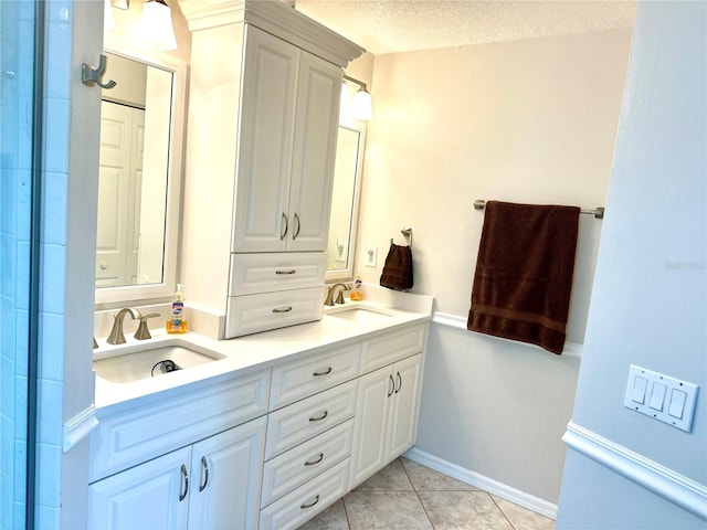 bathroom with vanity, tile patterned flooring, and a textured ceiling