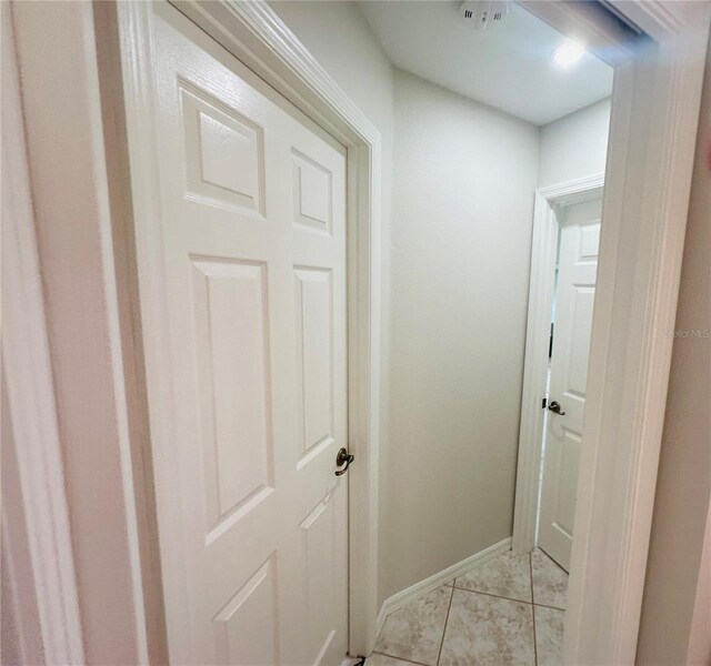 corridor featuring light tile patterned floors